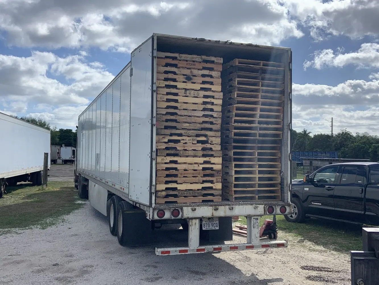 Open dry van trailer at industrial pallet staging area