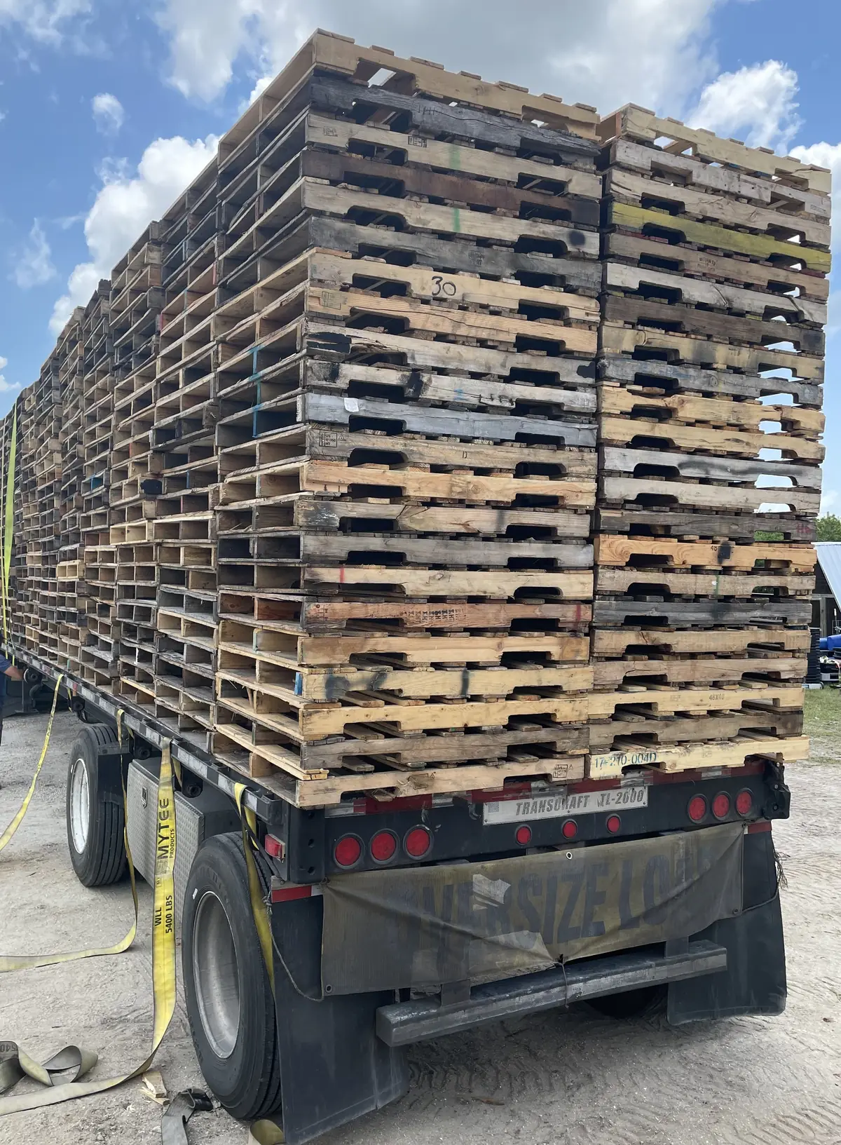 Flatbed truck loaded with pallets for warehouse
