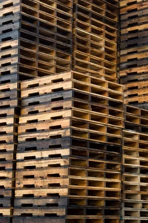 Tall recycled pallet stacks at warehouse inventory