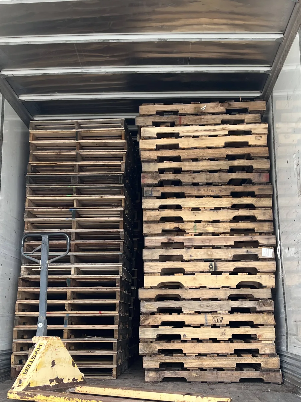 Pallets being loaded into dry van by forklift