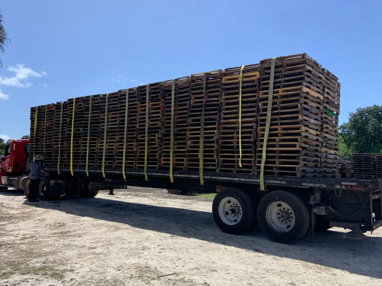 Red cab flatbed in national pallet fleet